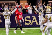 The Saints defence celebrates as Tampa Bay Buccaneers quarterback Tom Brady (12) walks back to the sideline after throwing an interception for a touchdown to cornerback P.J. Williams during the second half at Caesars Superdome. 
