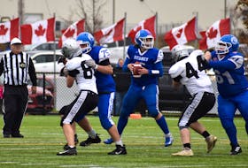 Sydney Academy Wildcats quarterback Garrett Mofford, middle, looks for a pass option as Nolan Whiffen, left, and Nathan O'Neil, right, block during School Sport Nova Scotia Division 2 high school football semifinal action against the Lockview Dragons of Fall River at Open Hearth Park Turf in Sydney, Sunday. Lockview won the game 14-10. JEREMY FRASER/CAPE BRETON POST.