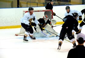 Captain James Melindy (left), goaltender Evan Cormier and the Newfoundland Growlers are shown in a practice at the Mount Pearl Glacier last month. After originally planning to play their first homestand of the 2021 ECHL season in Toronto because they've been banned from using Mile One Centre in St. John's, the team now says it will play those games at the Conception Bay South Arena. — Keith Gosse/The Telegram