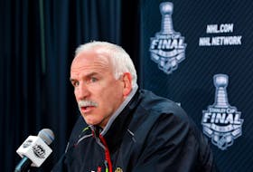 Former Chicago Blackhawks head coach Joel Quenneville answers a question from a reporter in Chicago in June 2013 after Game 5 of his team's NHL Stanley Cup Finals hockey series against the Boston Bruins. Quenneville, who had since moved on to coach the Florida Panthers, resigned last week after an independent report found the Blackhawks failed to act on allegations of sexual assault made by a former player against a coach in 2010. REUTERS/Jeff Haynes