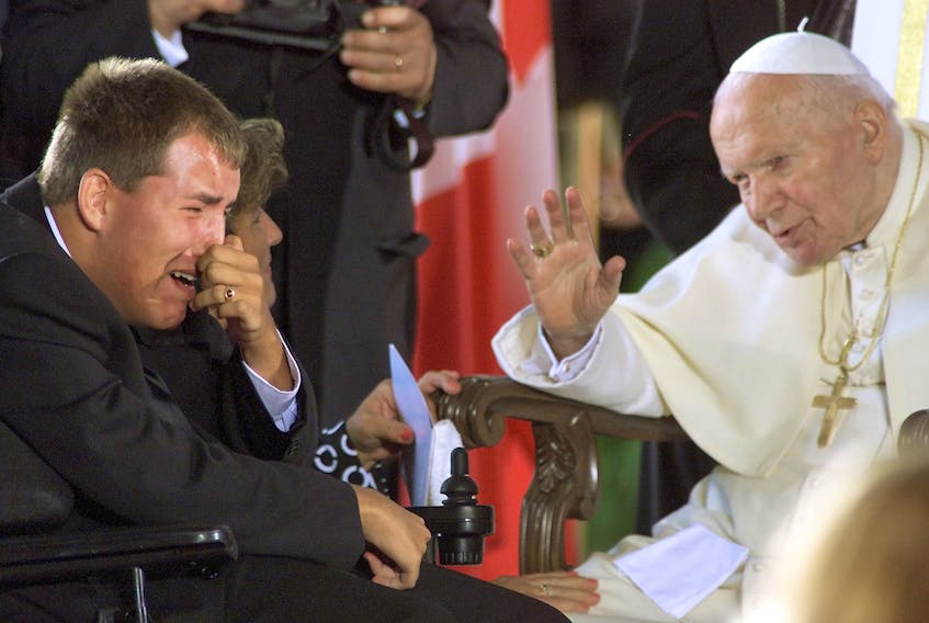  Pope John Paul II blesses stroke victim Anthony Ramuschak, 16, of Hamilton, during one of his visits to Toronto.