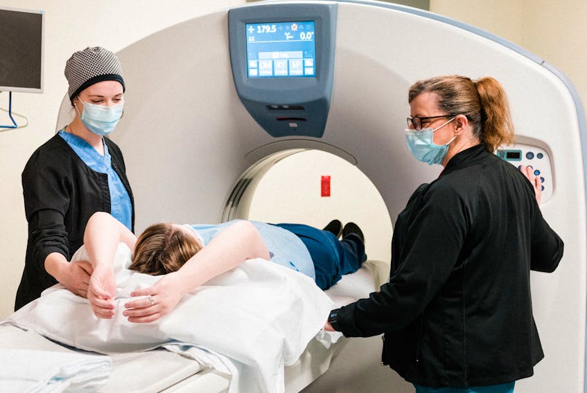 CT technologists Caitlin Edgar and Janine Cross using a CT scanner in the Valley Regional Hospital’s diagnostic imaging department. CONTRIBUTED