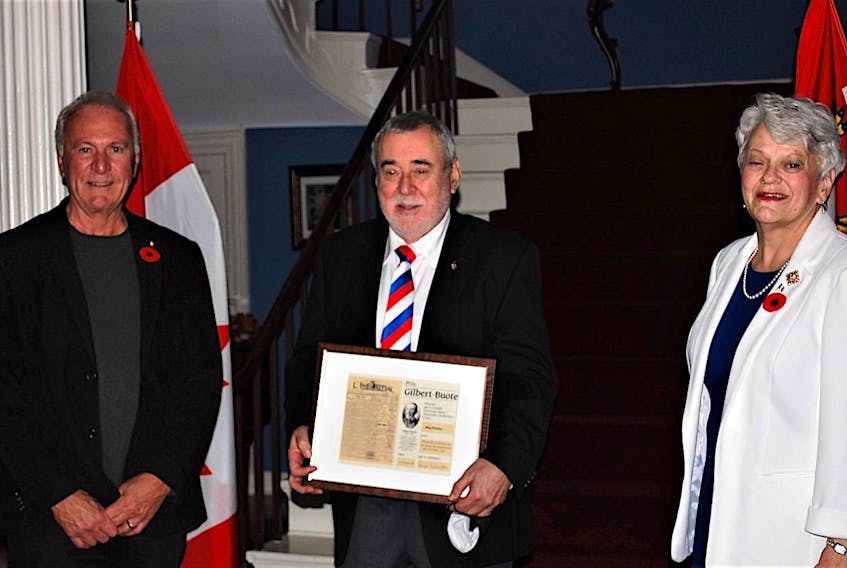 Georges Arsenault (left) member of the Sister Antoinette DesRoches Historical Committee and P.E.I. Lieutenant Governor Antoinette Perry (right) present Reg Porter (middle) with the Gilbert Buote Award for his work researching the maps of Ile Saint-Jean.