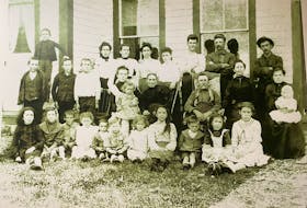 Muise and Gaudet families in front of Muise homestead, at Frog Point, 1903. Rene Gaudet (middle row, first person on left) was one of 16 children.
Addie Boudreau is sitting in the front row, fourth from the right.
