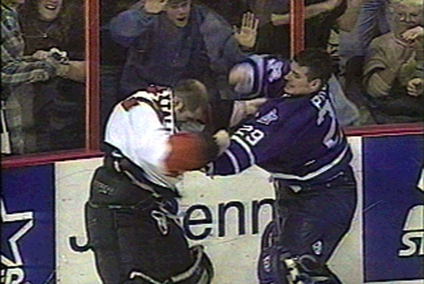 Maple Leafs goalie Felix Potvin pounds the stuffing out of Flyers goalie Ron Hextall during a donnybrook at the end of the game.