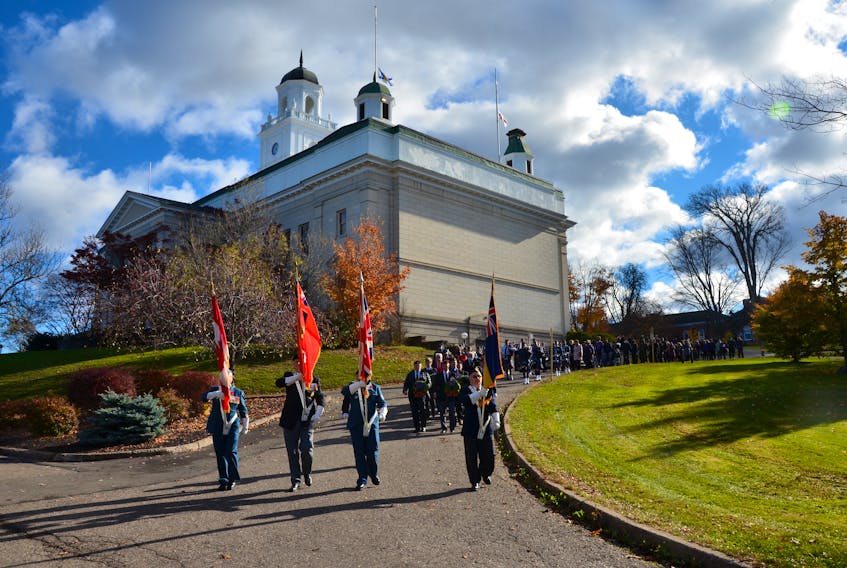 The Wolfville Legion flag party leads a Remembrance Day procession from University Hall to the Acadia University war memorial. KIRK STARRATT