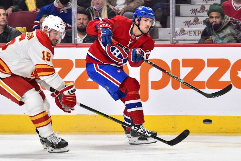  Ryan Poehling of the Montreal Canadiens shoots the puck past Brad Richardson of the Calgary Flames during the second period at the Bell Centre on Nov. 11, 2021.