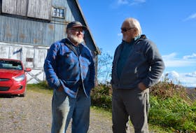 Kings County Coun. Dick Killam, right, speaks with Don Baker at the Grafton man's farm property. Baker isn’t giving up on his dream of building a small house and working the land. KIRK STARRATT