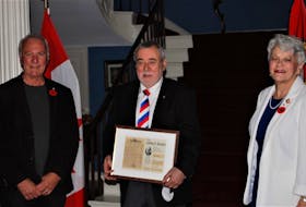 Georges Arsenault, left, member of the Sister Antoinette DesRoches historical committee and P.E.I. Lt.-Gov. Antoinette Perry present Reg Porter with the Gilbert Buote Award for his work researching the maps of Ile Saint-Jean.