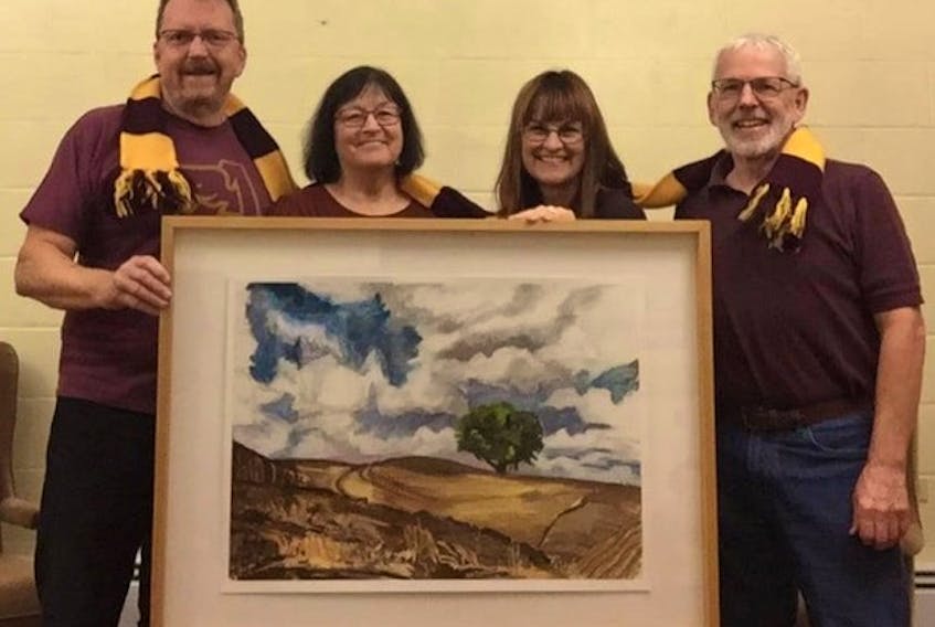 Local Mount Allison grads who will be preforming in the concert holding one of the art pieces "Ploughed Field With Tree" by Hallie Watson.
John Muirhead, Janette Keefe, Clare Grieves and Dave Pos.