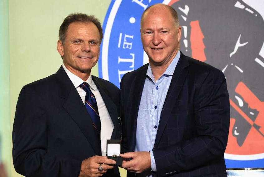 Member of the selection committee Mike Gartner (L) presents a Hall of Fame ring to Kevin Lowe at the Hockey Hall Of Fame on November 12, 2021 in Toronto. 