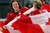  Cassie Campbell and Kim St-Pierre hold Canadian flags and celebrate their 4-1 victory over Sweden to win the gold medal at the 2006 Olympic Games in Torino.