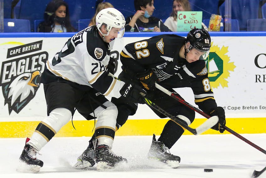 The Charlottetown Islanders’ Matis Ouellet, 28, and Mikhail Nizovkin, 82, of the Cape Breton Eagles focus on the puck in a Quebec Major Junior Hockey League game at Centre 200 in Sydney, N.S., on Nov. 13. The Islanders won the game 5-2. Mike Sullivan Photo