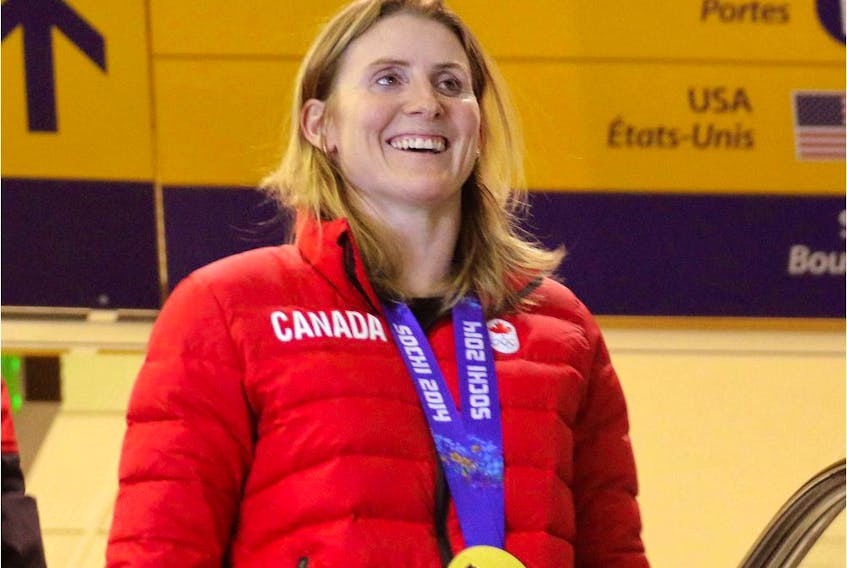  Hayley Wickenheiser smiles as she sees the crowd waiting for her and her teammates from the Olympic Winter Games gold medal winning women’s hockey team as they arrive at the Calgary International Airport in Calgary, Alta., on Tuesday February 25, 2014.