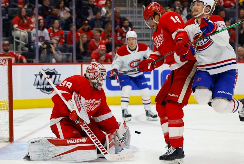Red Wings goaltender Alex Nedeljkovic makes a save in front of defenceman Marc Staal (18) and Canadiens' Artturi Lehkonen (62) at Little Caesars Arena in Detroit on Saturday, Nov.  13, 2021. 