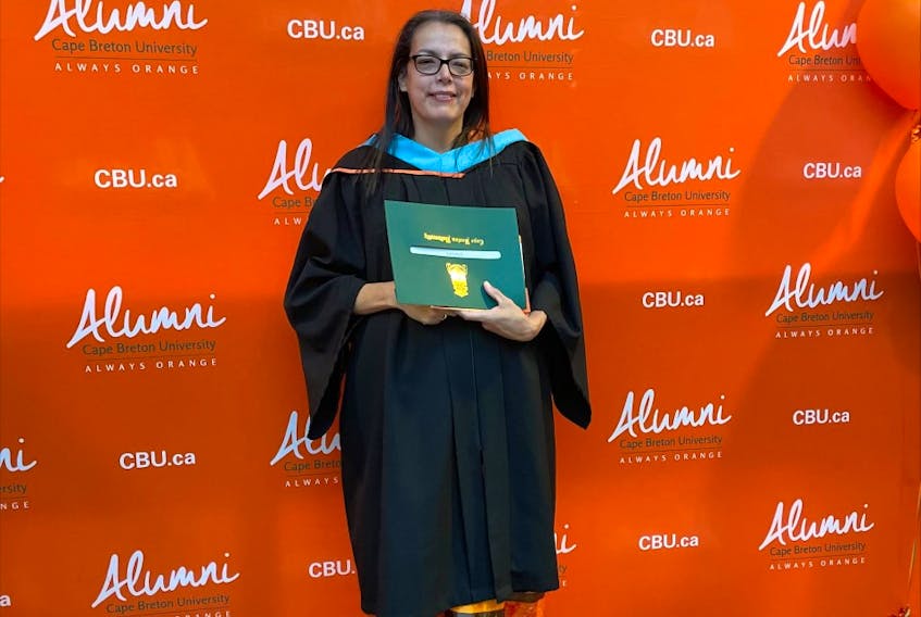 Mary Lou Gould poses for photos on her graduation day at Cape Breton University earlier this month. Gould, 50, earned a bachelor of education degree after what she calls "a long and winding journey." CONTRIBUTED