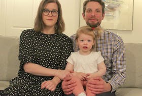 Kristin MacDonald and her husband David Taylor hold their 20-month-old daughter Poppy, who was born through in-vitro fertilization treatment. MacDonald is one of many people upset by a message in St. Joseph’s Catholic Church’s bulletin that calls artificial insemination and artificial fertilization “immoral.” MacDonald and other people are planning to stage a protest at the North Sydney church’s mass Sunday morning. Chris Connors/Cape Breton Post