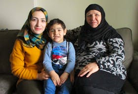 Syrian refugee Nahed Osman, left, sits with her son and Mother, Suaad Rustum. They hope to welcome one of Suaad’s sons and
his family to Wolfville soon. A Canning family is similarly waiting to reunite as well.
Wendy Elliott