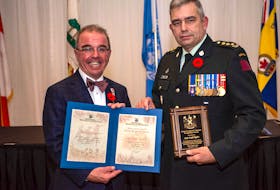 Charlottetown Mayor Philip Brown presents Capt. Leigh Taylor with the Mayor and Council Veterans Recognition Award at the awards ceremony. Taylor was one of six recipients.