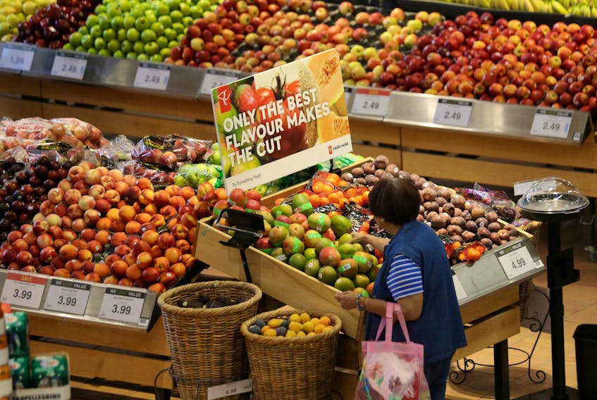 A woman browses in the fruit section of a Loblaw supermarket in Collingwood, Ont. on July 28, 2017.  