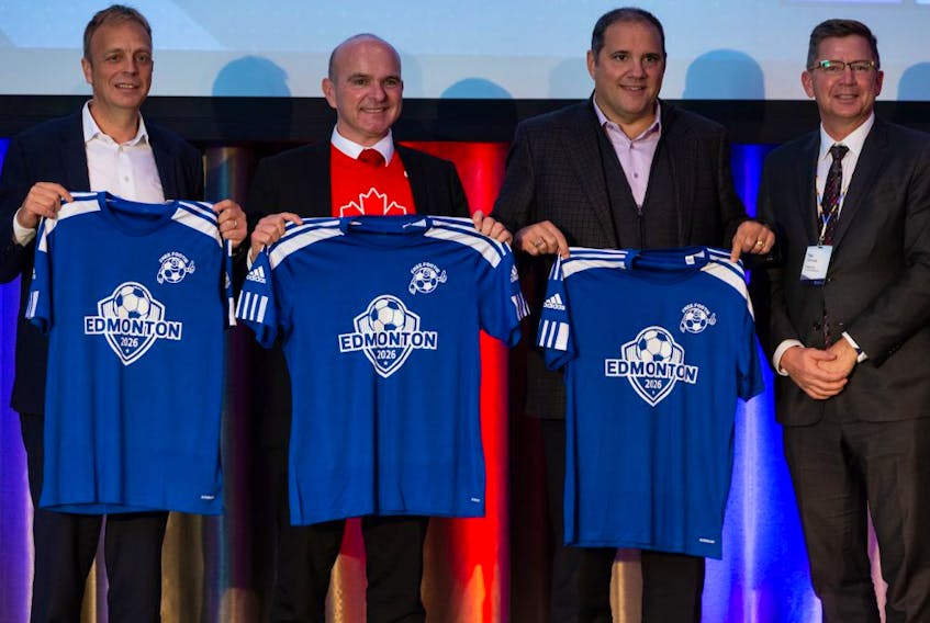 FIFA representatives Vice-President and Concacaf President Victor Montagliani (second from right) and Colin Smith (left), Chief Tournaments and Events Officer, receive Edmonton jerseys next to Randy Boissonnault, (second from left), Minister of Tourism and Associate Minister of Finance, and Coun. Tim Cartmell during a press conference at the JW Marriott in Edmonton, on Wednesday, Nov. 17, 2021. Photo by Ian Kucerak