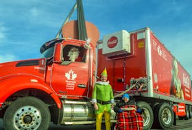 From left, Donnie Maclennan of Moncton as Santa Claus and Allan MacDonald of New Waterford as Buddy the Elf stand with Gabriel Wall of Whitney Pier at the Coca-Cola Holiday Truck in front of the Big Fiddle in Sydney. The truck will be driven by Santa across Canada and began its tour in St. John's, N.L., on Nov. 13. JESSICA SMITH/CAPE BRETON POST