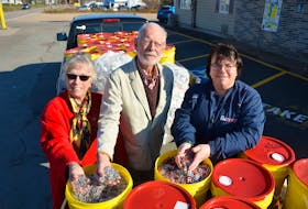 Middleton Rotary Club president Sharon Hutton, left, Brian Neville, chair of the Middleton Rotary Club can tab committee, and The Big Scoop restaurant owner Angie Cress display nearly 1,500 pounds of aluminum can tabs. KIRK STARRATT