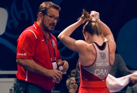 Hannah Taylor discusses strategy with coach Dave Collie at the recent under-23 world wrestling championships in Belgrade, Serbia. Taylor, who is from Prince Edward Island, won a bronze medal.