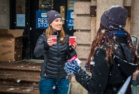 Angela Picco, Choices For Youth’s manager of fund development and communication, hands out a hot drink in St. John's, NL. The organization supports young people and young families with housing, education, employment, and health needs.