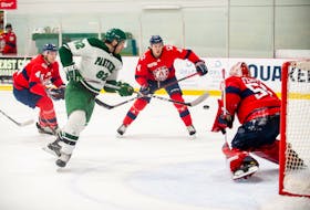 The UPEI Panthers’ Jesse Sutton, 82, looks to deflect this shot on Acadia Axemen goaltender Logan Fiodell during an Atlantic University Sport men’s hockey game at MacLauchlan Arena in Charlottetown on Nov. 17. Acadia’s Reilly Webb, 44, and Orlando Mainolfi, 4, follow the play and move into position to support Fiodell. The Axemen won the game 5-4 in overtime. Janessa Hogan Photo/UPEI Athletics