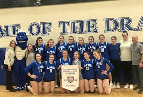 The Lockview Dragons girls' volleyball team pose with the Capital region Division 1 banner on Thursday night in Fall River.