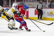 Montreal Canadiens' Cole Caufield holds off Pittsburgh Penguins' Marcus Pettersson during second period in Montreal Thursday, Nov. 18, 2021. 