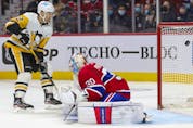 Penguins Zach Aston-Reese watches as the puck flies past Canadiens goalie Cayden Primeau during the second period Thursday night at the Bell Centre. 