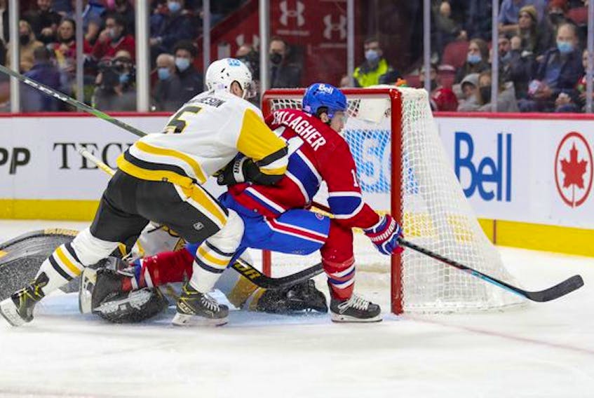 Montreal Canadiens' Brendan Gallagher is shoved off the puck by Pittsburgh Penguins' Michael Matheson next to goalie Tristan Jarry during third period in Montreal Thursday, Nov. 18, 2021.