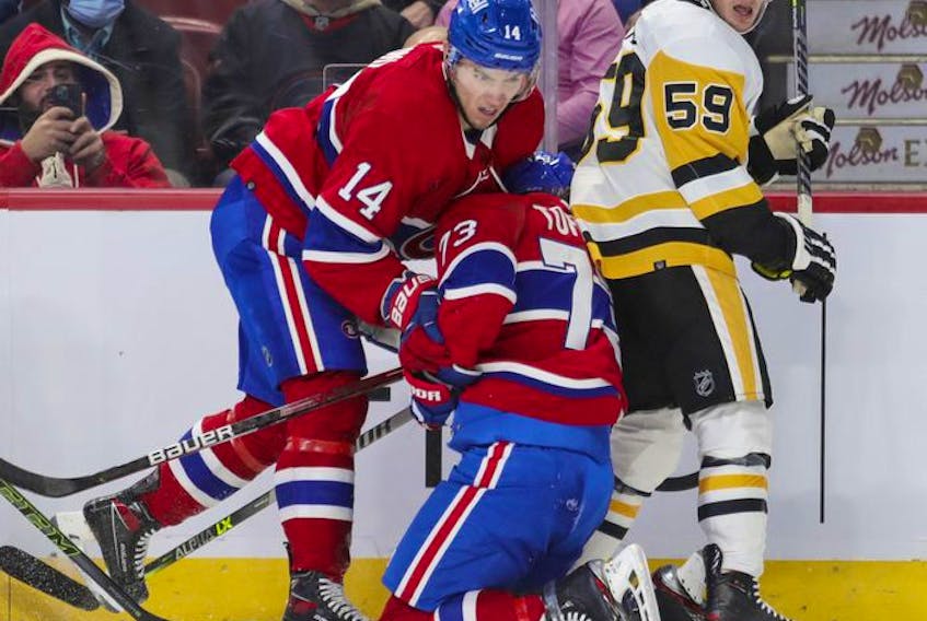 Montreal Canadiens' Nick Suzuki, left, collides with teammate Tyler Toffoli next to Pittsburgh Penguins' Jake Guentzel during first period in Montreal Thursday, Nov. 18, 2021.