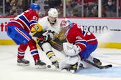 Pittsburgh Penguins' Teddy Bluger cuts between Montreal Canadiens defenceman Mattias Norlinder and goalie Cayden Primeau during second period in Montreal Thursday, Nov. 18, 2021. 