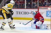 Montreal Canadiens' Cayden Primeau makes a save in front of Pittsburgh Penguins' Zach Aston-Reeves during second period in Montreal Thursday, Nov. 18, 2021. 