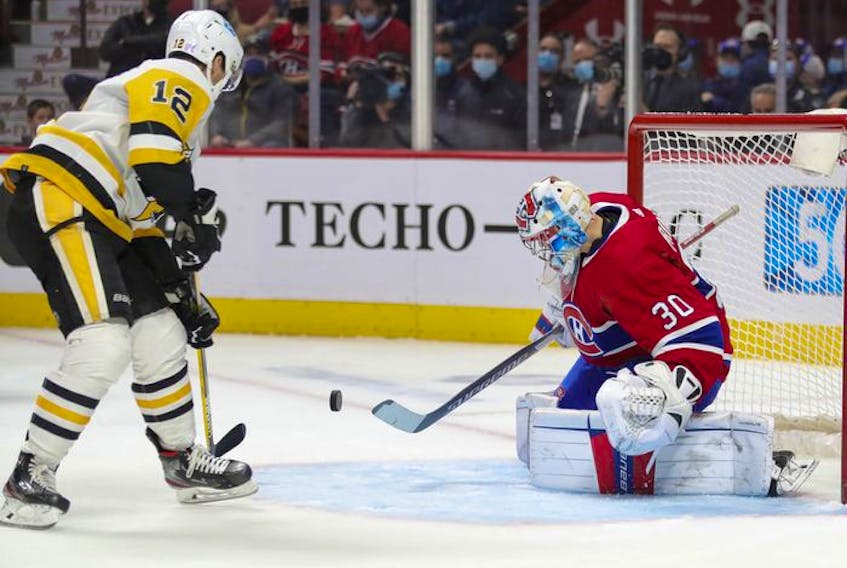 Montreal Canadiens' Cayden Primeau makes a save in front of Pittsburgh Penguins' Zach Aston-Reeves during second period in Montreal Thursday, Nov. 18, 2021. 