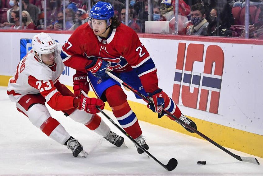 Canadiens' Alexander Romanov skates the puck against Lucas Raymond of the Detroit Red Wings during the first period at the Bell Centre on Saturday, Oct. 23, 2021, in Montreal.