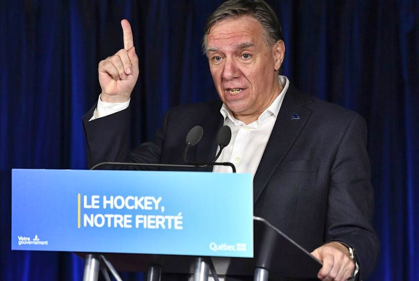 Quebec Premier François Legault, makes an announcement to develop the game of hockey within the province of Quebec and to increase the number of Quebecers in the NHL, prior to the game between the Montreal Canadiens and the Pittsburgh Penguins at the Bell Centre on Nov. 18, 2021, in Montreal.