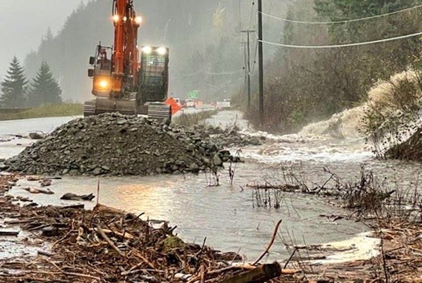 An excavator clears debris on a road after landslide and flooding British Columbia, Canada, November 15, 2021. B.C. Ministry of Transportation and Infrastructure.