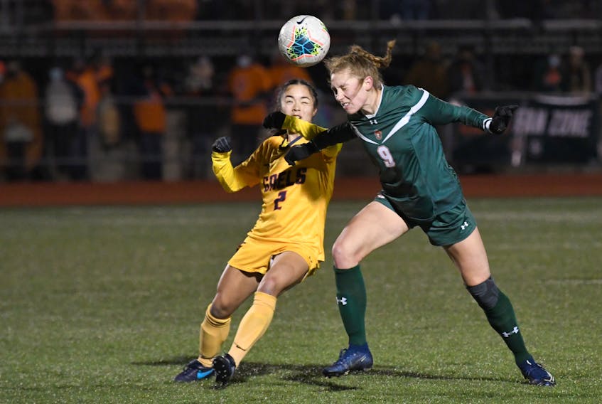 Jenna Matsukubo of the Queen's Gaels, right, and Emma Clark of the Cape Breton Capers battle for the battle during the U Sports Women's Soccer Championship consolation final at the Cape Breton Health Recreation Complex Turf in Sydney, Saturday. Queen's won the game 3-0. PHOTO CONTRIBUTED/VAUGHAN MERCHANT, CBU ATHLETICS.