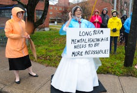 Mental health advocate Kristi Allan stands outside the Waterford Hospital in St. John’s Saturday Nov. 20 with a poster calling for better accessibility to long-term mental health services. She is a regular sight outside the hospital every Saturday morning for the last 50 weeks. Nov. 20 was no different, even though it also happened to be her wedding day. – Joe Gibbons/The Telegram