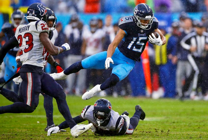 Nick Westbrook-Ikhine of the Tennessee Titans falls over a Houston Texans defender.