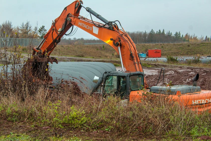 A worker digs in the field near the landfill at the New Victoria Water Treatment Plant. JESSICA SMITH/CAPE BRETON POST
