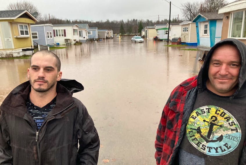 Kyle Ehler (left) and Jason Benoit are pictured after the waters had dropped in Indian Gardens Trailor Court in Antigonish. The two were part of a large scale rescue effort. (AARON BESWICK PHOTO)