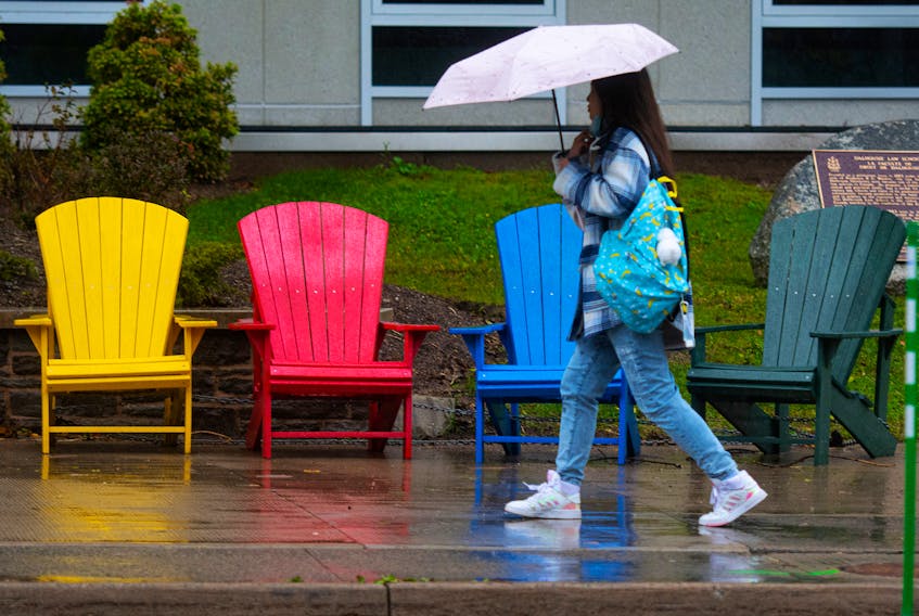 A student walks through the Dalhousie campus during a soggy morning on Tuesday, Nov. 23, 2021.