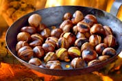  Roasting chestnuts in a special pan over an open fire – Getty Images
