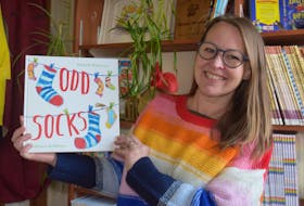 Michelle Robinson, a children's author from the U.K. who recently settled in Tatamagouche with her husband and two children, shown with Odd Socks, one of her many illustrated publications.