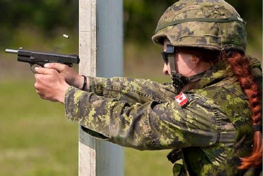 A 2012 file photo shows a Canadian firing a Browning Hi Power pistol in the Canadian Armed Forces Small Arms Concentration at Connaught Ranges in Ottawa